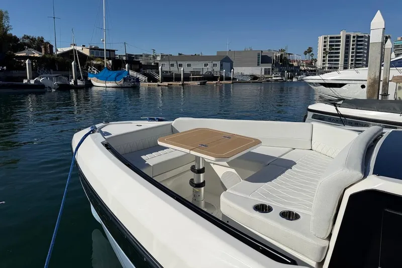Slide: The Image of 2026 Saxdor 400 GTC boat with elegant seating and table in a marina setting. - 42