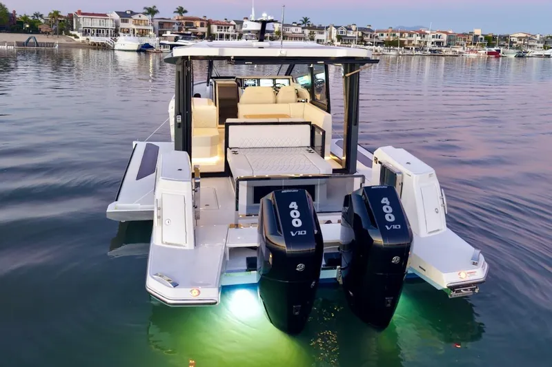 Slide: The Image of 2026 Saxdor 400 GTC boat with dual Mercury 400 V10 engines on calm water. - 8