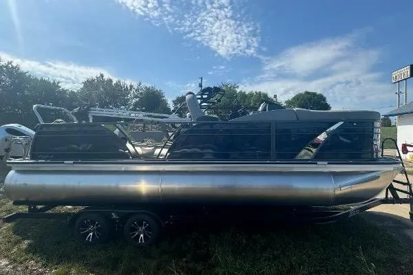 The Image of 2024 Veranda VTX 22VLB pontoon boat on trailer under a clear blue sky. - 0