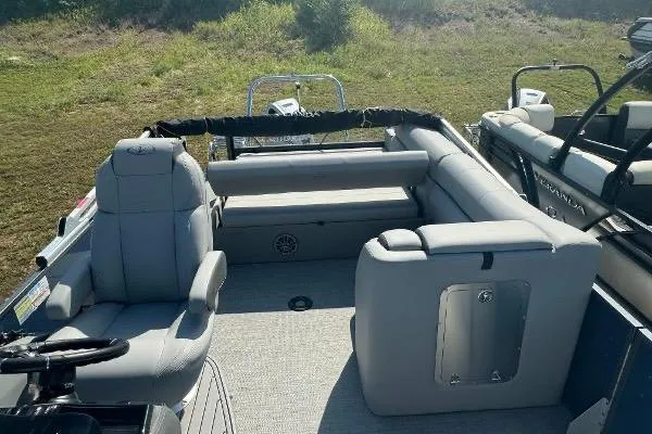 Slide: The Image of 2024 Veranda VTX 22VLB pontoon boat interior with gray seating and steering wheel. - 3