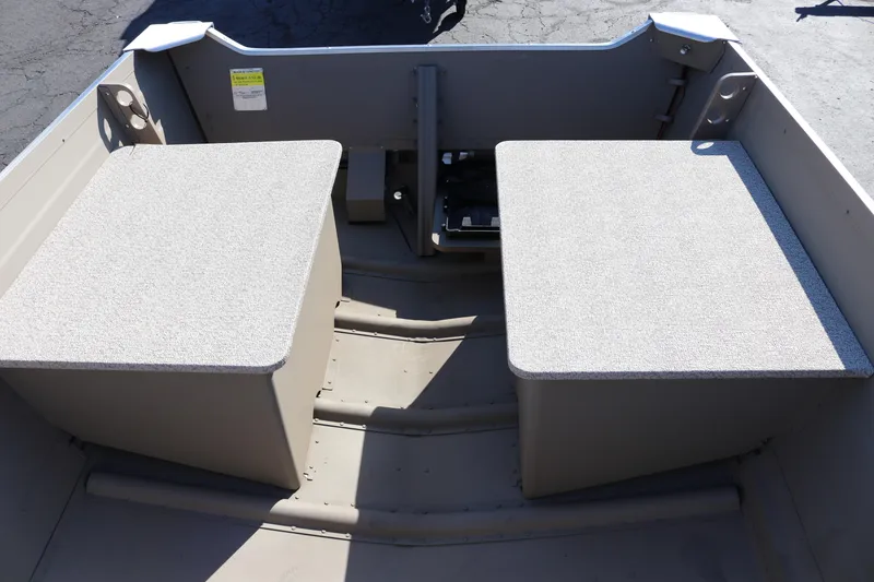 Slide: The Image of 2025 Smoker Craft Voyager 16 interior with dual seating and storage compartments. - 11