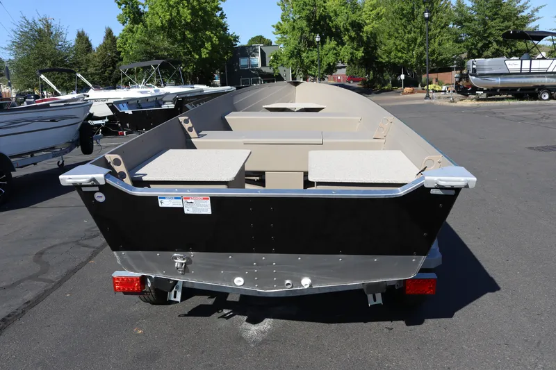 Slide: The Image of 2025 Smoker Craft Voyager 16 boat on trailer, parked outdoors. - 3