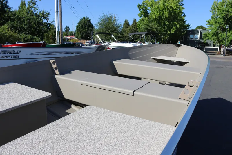 Slide: The Image of 2025 Smoker Craft Voyager 16 boat interior with seating and storage compartments. - 6