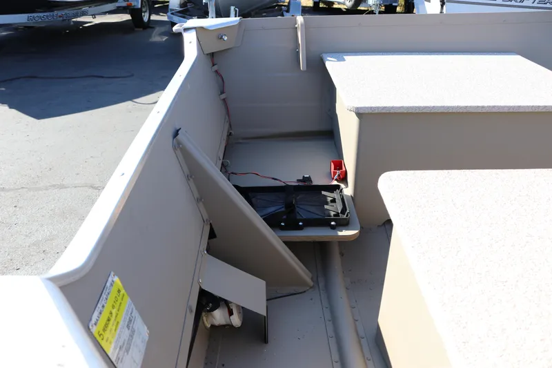 Slide: The Image of 2025 Smoker Craft Voyager 16 interior with storage compartments and wiring details. - 7