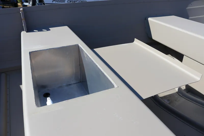 Slide: The Image of 2025 Smoker Craft Voyager 16 boat interior with storage compartment and seating. - 8