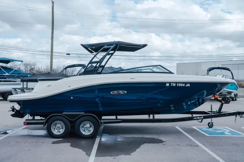 Slide: The Image of 2024 Sea Ray SPX 230 boat on trailer in parking lot, side view. - 1