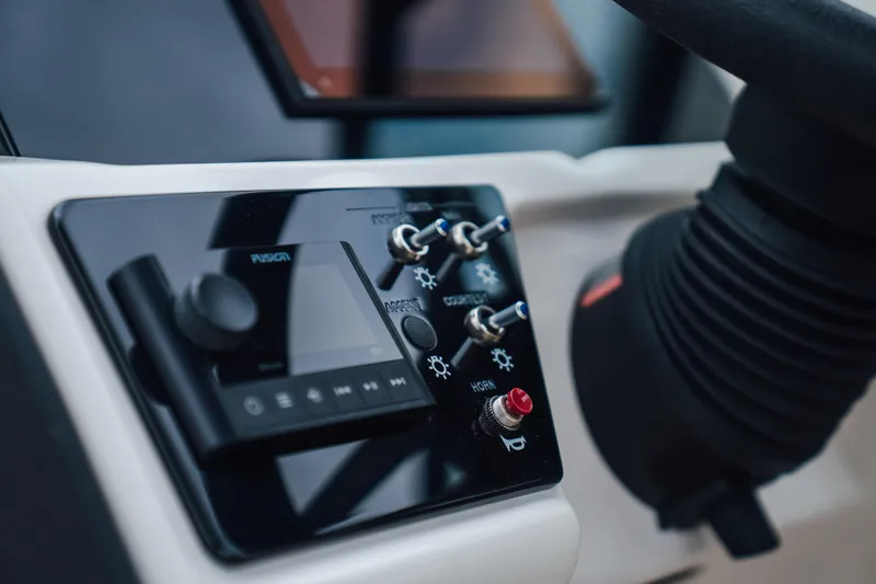 Slide: The Image of Control panel of 2024 Sea Ray SPX 230 boat with switches and display. - 10