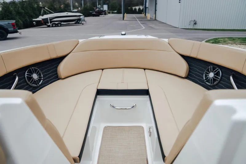 Slide: The Image of 2024 Sea Ray SPX 230 boat interior with tan seating and built-in speakers. - 12