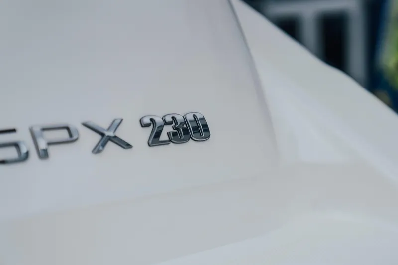 Slide: The Image of 2024 Sea Ray SPX 230 boat emblem on white surface. - 4