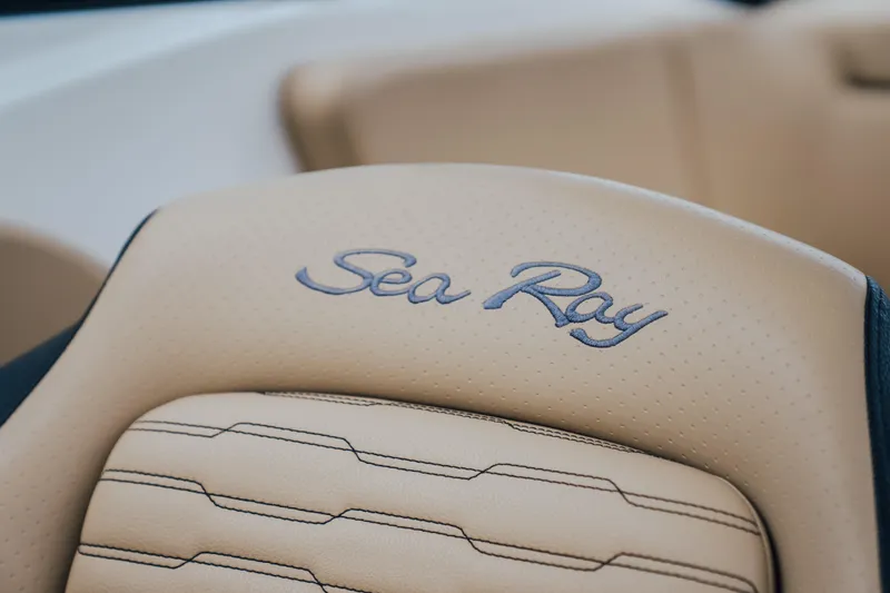 Slide: The Image of 2024 Sea Ray SPX 230 boat seat with embroidered logo, beige upholstery. - 7
