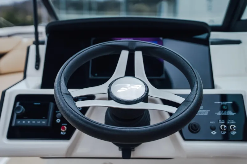 Slide: The Image of Steering wheel of 2024 Sea Ray SPX 230 boat, featuring modern dashboard controls. - 9