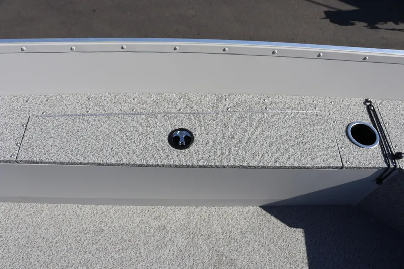 Slide: The Image of 2025 Smoker Craft Angler 16 XL TL boat interior with storage compartment and cup holder. - 11