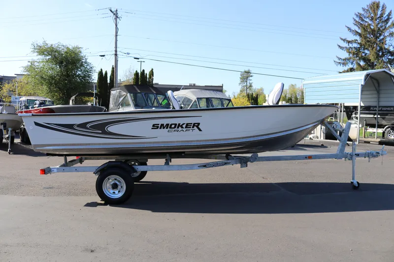 Slide: The Image of 2025 Smoker Craft Angler 16 XL TL boat on trailer, parked outdoors. - 3