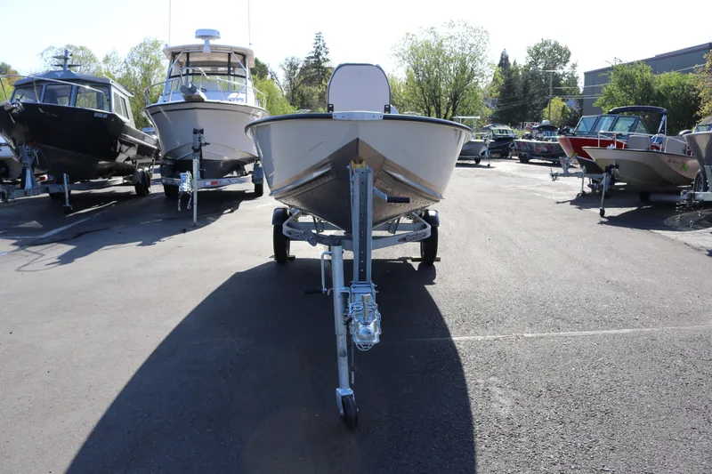 Slide: The Image of 2025 Smoker Craft Angler 16 XL TL boat on trailer in a marina. - 4