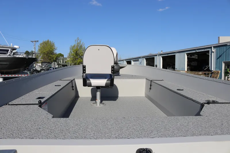 Slide: The Image of 2025 Smoker Craft Angler 16 XL TL boat with central seat, docked outdoors. - 5