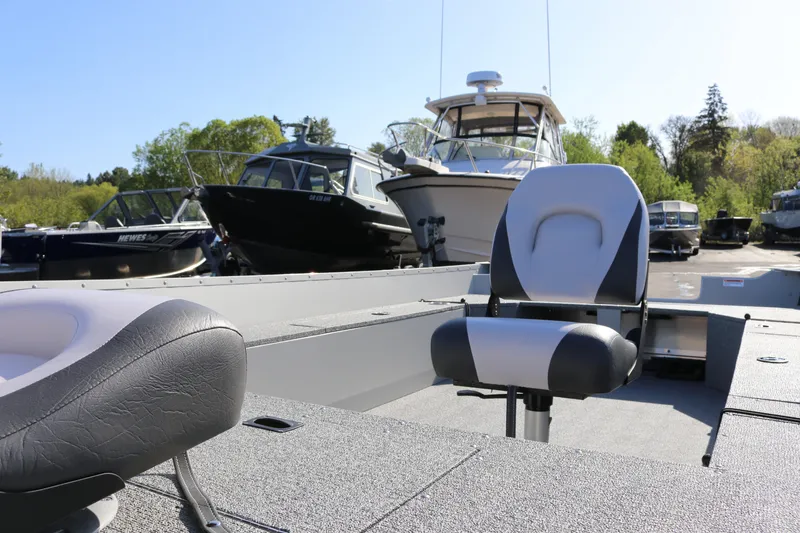 Slide: The Image of 2025 Smoker Craft Angler 16 XL TL boat with seating, docked among other boats. - 6