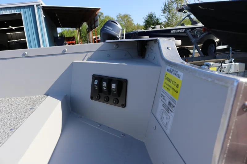 Slide: The Image of 2025 Smoker Craft Angler 16 XL TL boat interior with control panel and capacity label. - 7