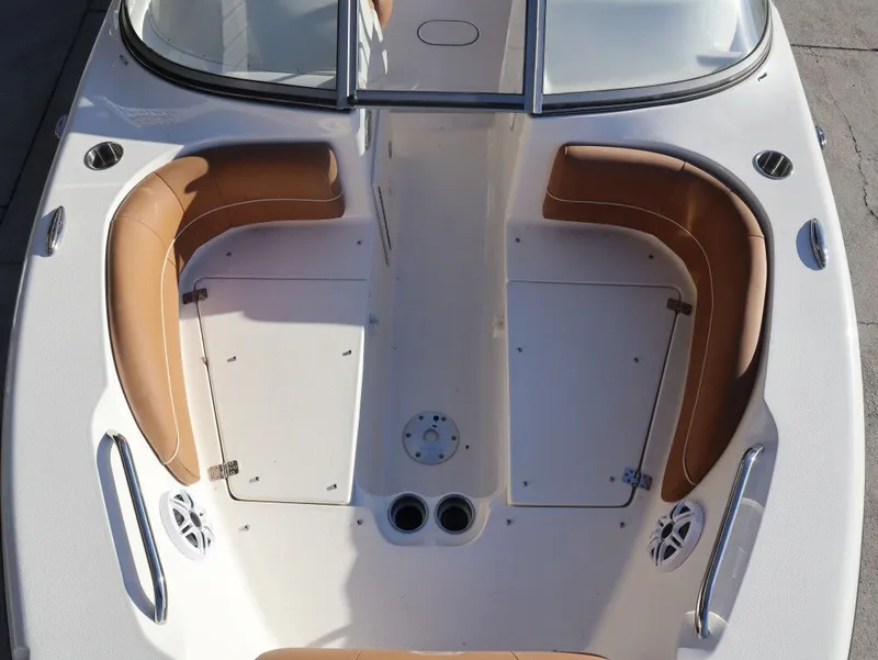 Slide: The Image of Key West 203 DFS 2026 boat with brown seating and speakers. - 9