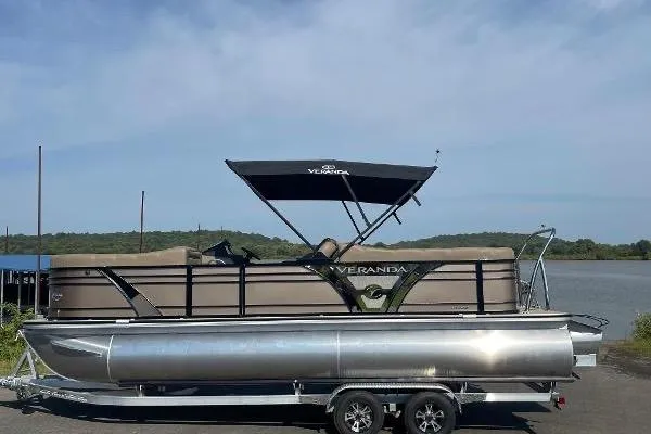 Slide: The Image of 2024 Veranda VTX 22RC pontoon boat on trailer by a lake. - 11