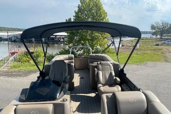 Slide: The Image of 2024 Veranda VTX 22RC pontoon boat with canopy, docked near a scenic lakeside marina. - 6