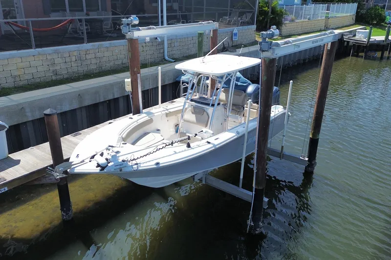 The Image of 2022 Key West 244 Center Console boat on lift at dockside. - 0