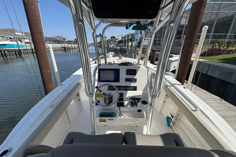 Slide: The Image of 2022 Key West 244 Center Console boat docked, featuring modern navigation equipment and sleek design. - 22