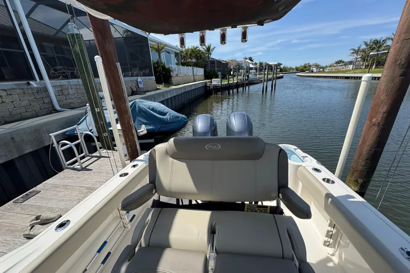Slide: The Image of 2022 Key West 244 Center Console boat docked by a serene canal. - 25