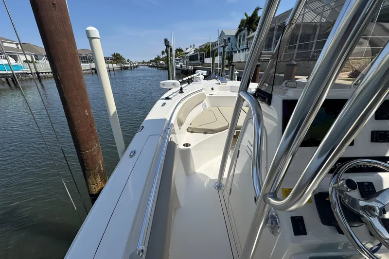 Slide: The Image of 2022 Key West 244 Center Console boat docked in a scenic canal setting. - 32