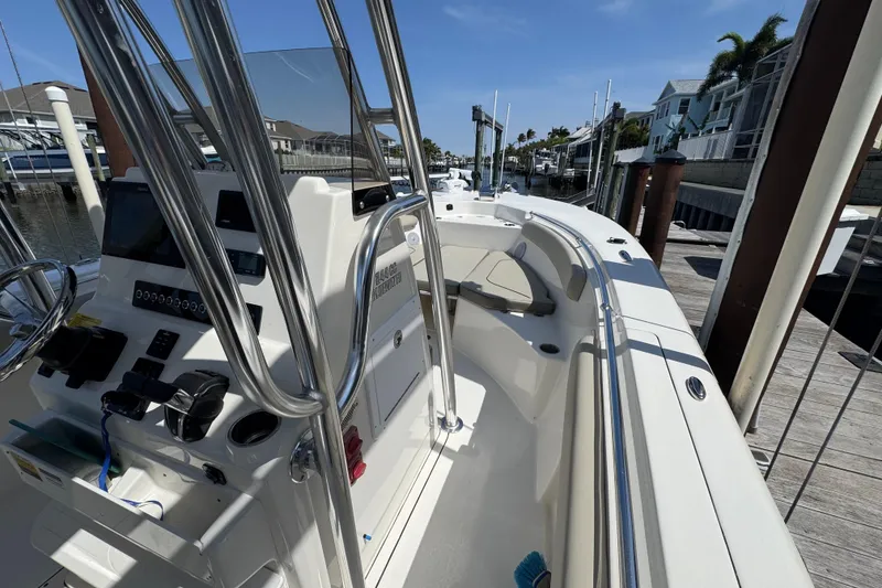 Slide: The Image of 2022 Key West 244 Center Console boat docked, showcasing helm and seating area. - 33