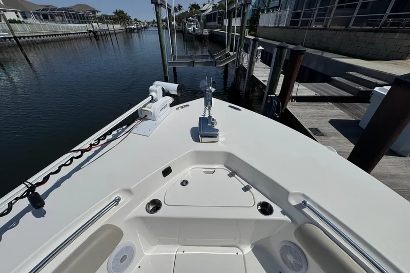Slide: The Image of 2022 Key West 244 Center Console boat docked in a serene canal setting. - 40