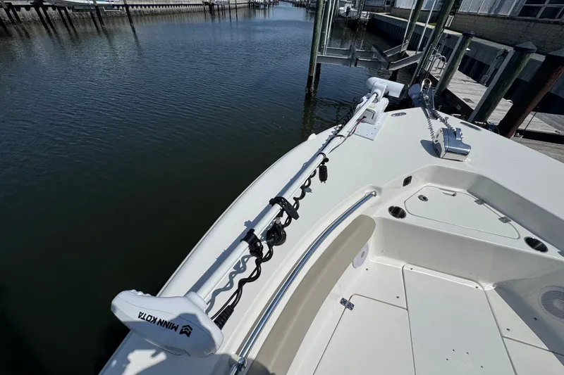 Slide: The Image of 2022 Key West 244 Center Console boat with Minn Kota trolling motor on calm water. - 45