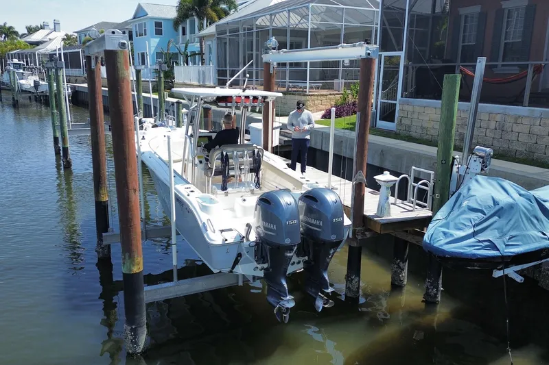Slide: The Image of 2022 Key West 244 Center Console boat docked with dual Yamaha engines. - 5