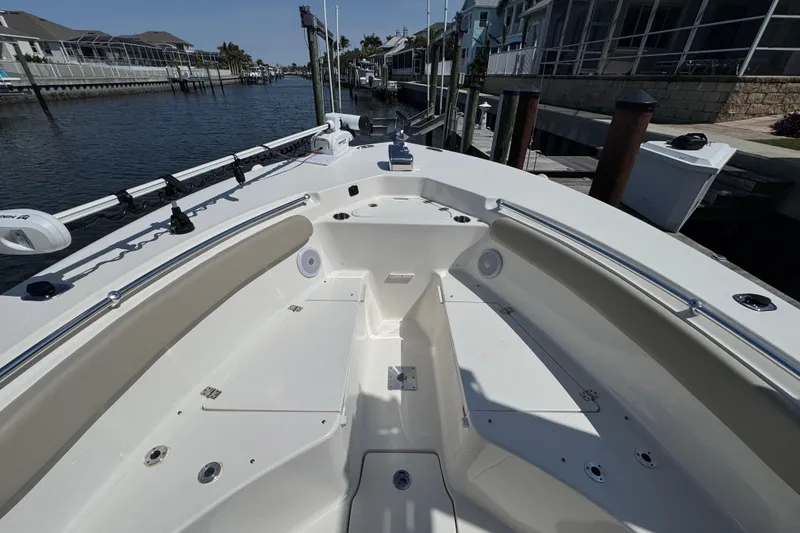 Slide: The Image of 2022 Key West 244 Center Console boat docked in a canal, showcasing spacious seating. - 50