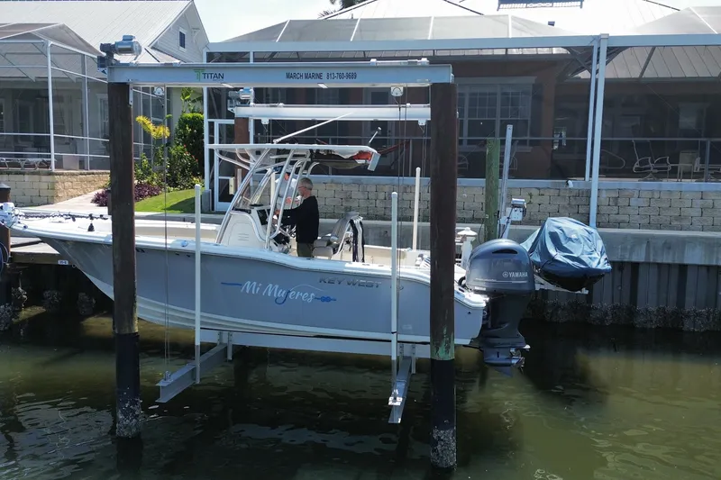 Slide: The Image of 2022 Key West 244 Center Console boat docked with Yamaha engine, in a residential marina. - 6
