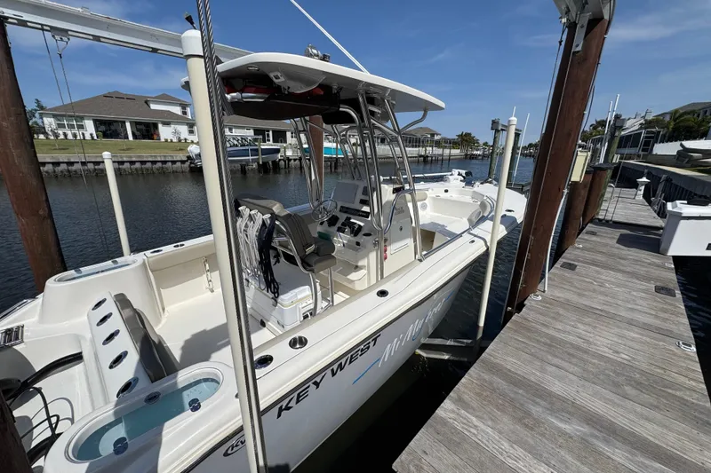 Slide: The Image of 2022 Key West 244 Center Console boat docked at a marina, sunny day. - 9
