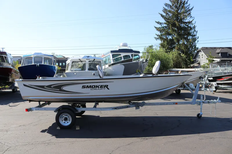The Image of 2025 Smoker Craft Angler 16 XL TL boat on trailer in outdoor showroom. - 0