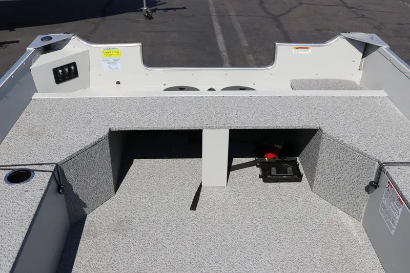 Slide: The Image of 2025 Smoker Craft Angler 16 XL TL boat interior with gray carpeted seating and storage. - 10