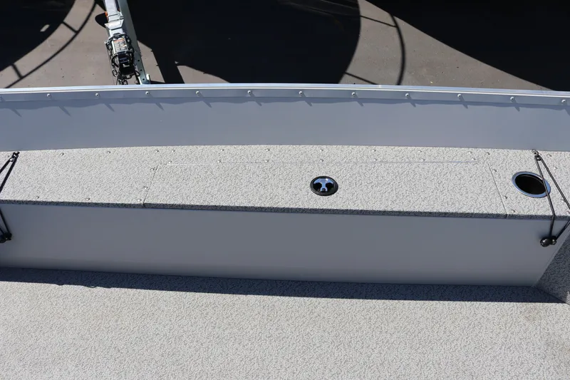 Slide: The Image of 2025 Smoker Craft Angler 16 XL TL boat interior with storage compartment and cup holder. - 11