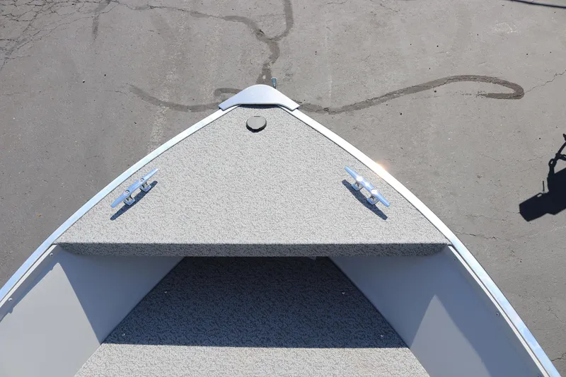 Slide: The Image of Bow of 2025 Smoker Craft Angler 16 XL TL boat with carpeted deck. - 12