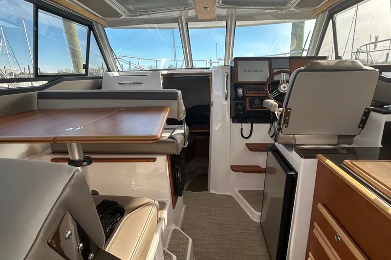 Slide: The Image of Interior of 2024 Cutwater C-288 Coupe boat with modern helm and seating area. - 12