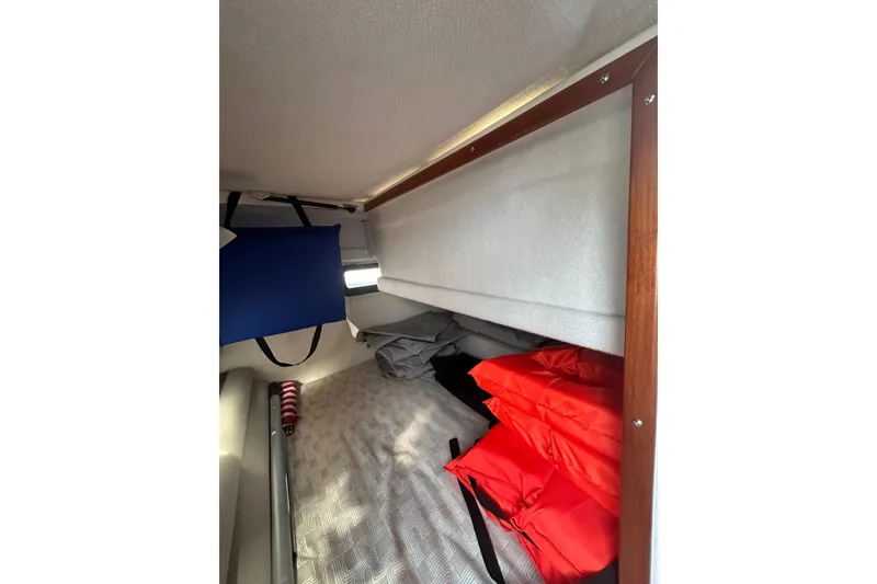 Slide: The Image of 2024 Cutwater C-288 Coupe interior storage with life jackets and accessories. - 21