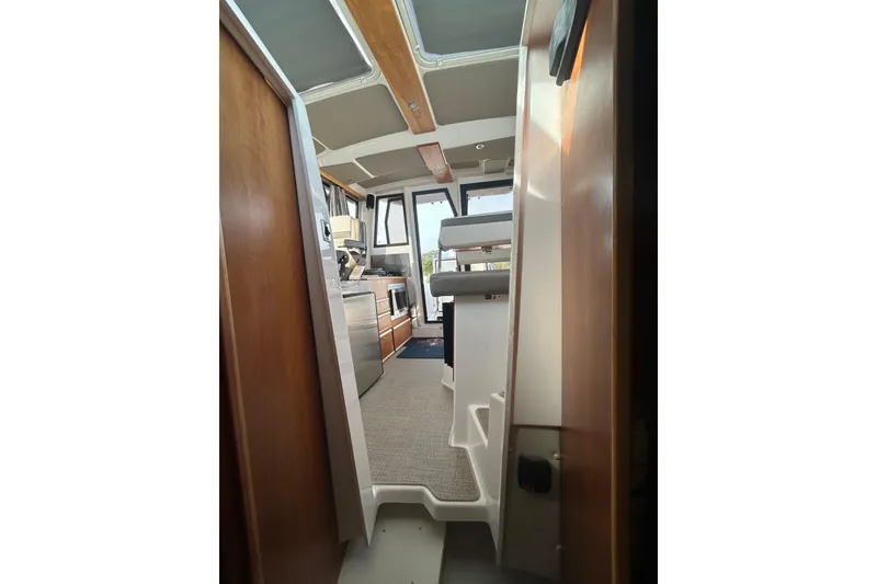 Slide: The Image of Interior view of 2024 Cutwater C-288 Coupe, showcasing stairs and cabin layout. - 28