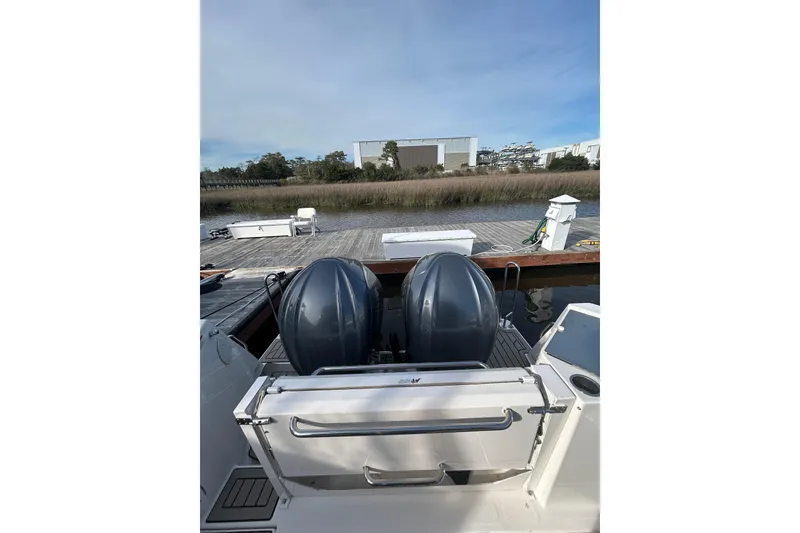 Slide: The Image of 2024 Cutwater C-288 Coupe at dock with dual outboard motors. - 33