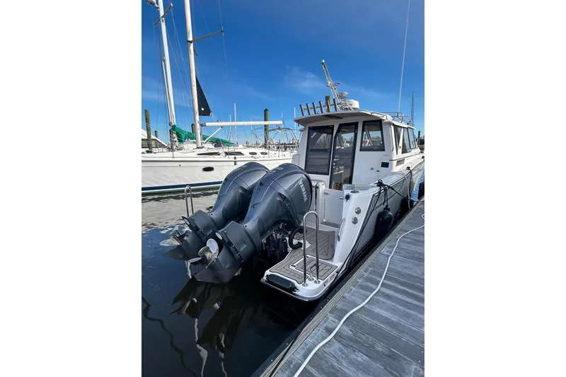 Slide: The Image of 2024 Cutwater C-288 Coupe boat docked with dual outboard engines. - 35