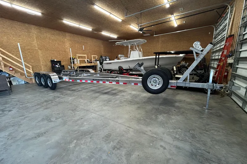 Slide: The Image of 2024 Cutwater C-288 Coupe in a garage with a boat trailer. - 36