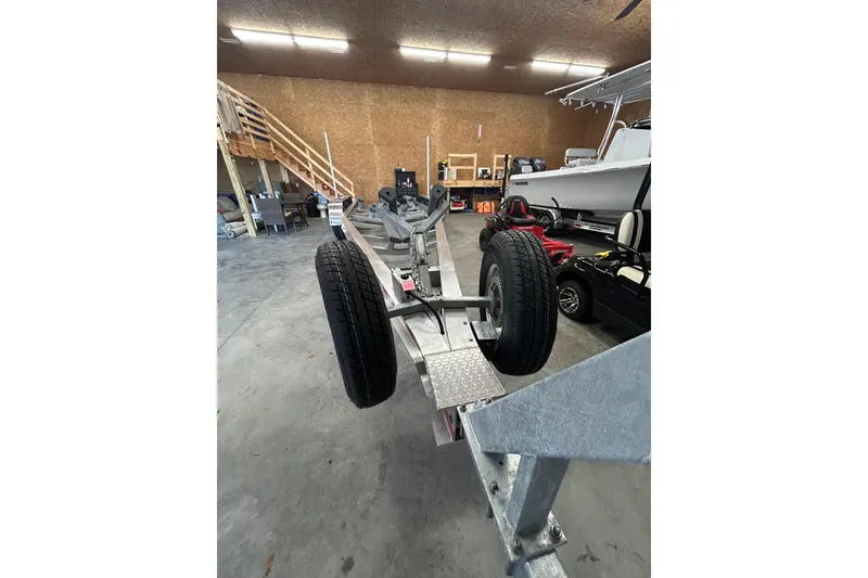 Slide: The Image of 2024 Cutwater C-288 Coupe boat trailer in a spacious indoor storage facility. - 37