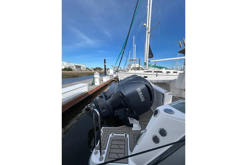 Slide: The Image of 2024 Cutwater C-288 Coupe with Yamaha engine docked at marina under clear blue sky. - 4