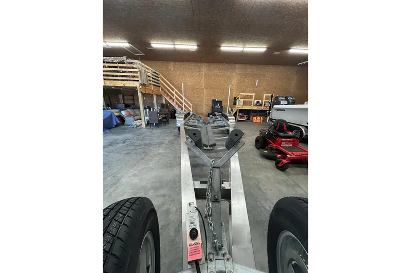 Slide: The Image of Indoor view of a 2024 Cutwater C-288 Coupe trailer in a garage setting. - 40