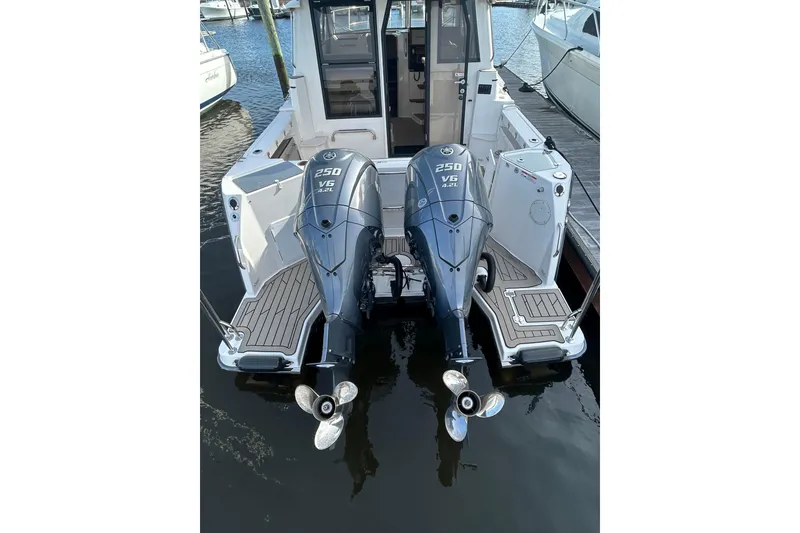 Slide: The Image of 2024 Cutwater C-288 Coupe with dual 250 V6 outboard engines at dock. - 7