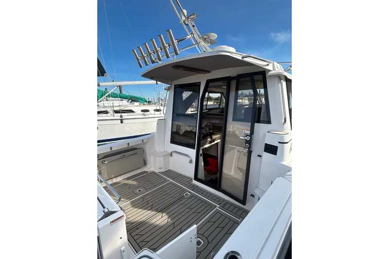 Slide: The Image of 2024 Cutwater C-288 Coupe boat with sleek deck and modern cabin entrance. - 8